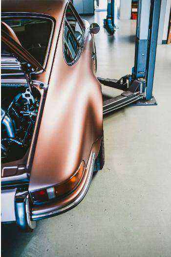 Technician inspecting car for logbook service